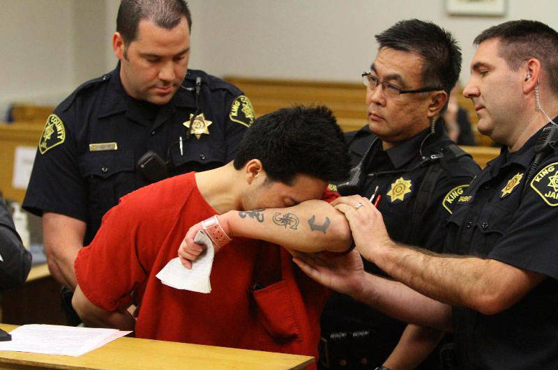 King County Corrections officers escort an inmate in court. COURTESY FILE PHOTO, King County Corrections Guild