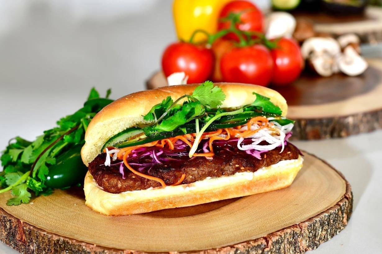 The Banh Mi Burger contains a lemongrass patty, pickled daikon carrots, pickled red cabbage, cilantro, jalapenos, plant-based mayonnaise, cucumber, umami sauce, and fresh cracked pepper. Courtesy of Plantiful Superfoods.