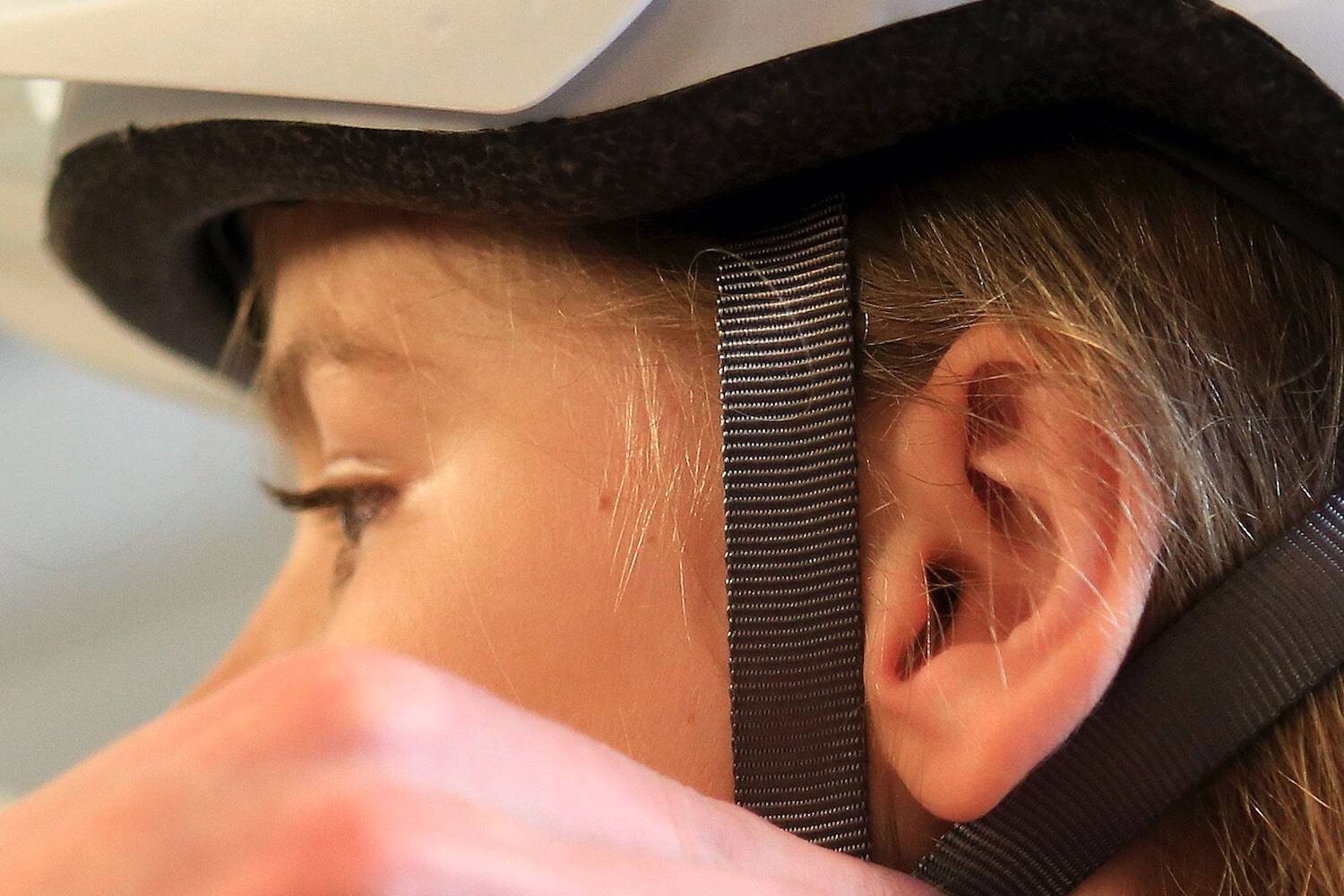 Cadence Patton, 9, gets properly fitted for a bike helmet at Bayside Bikes in Everett on June 17, 2016. Sound Publishing file photo