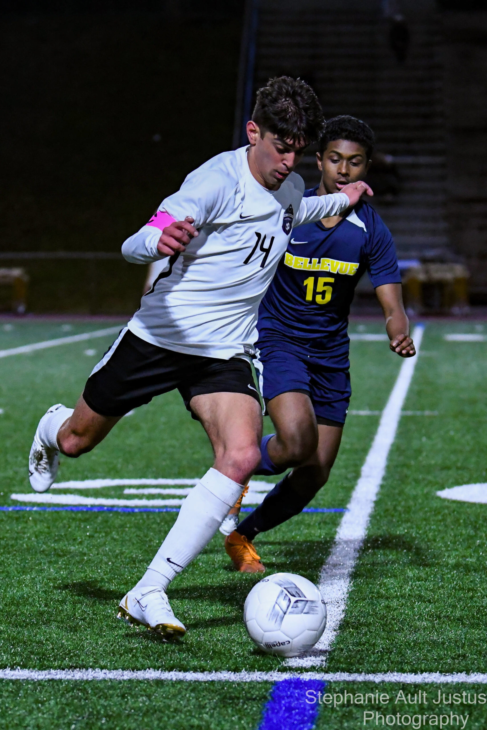 LWHS senior Dev Dhawan (#14) dribbles the soccer ball past BHS’s sophomore, Nathanael Simon (#15). Courtesy of Stephanie Ault Justus.