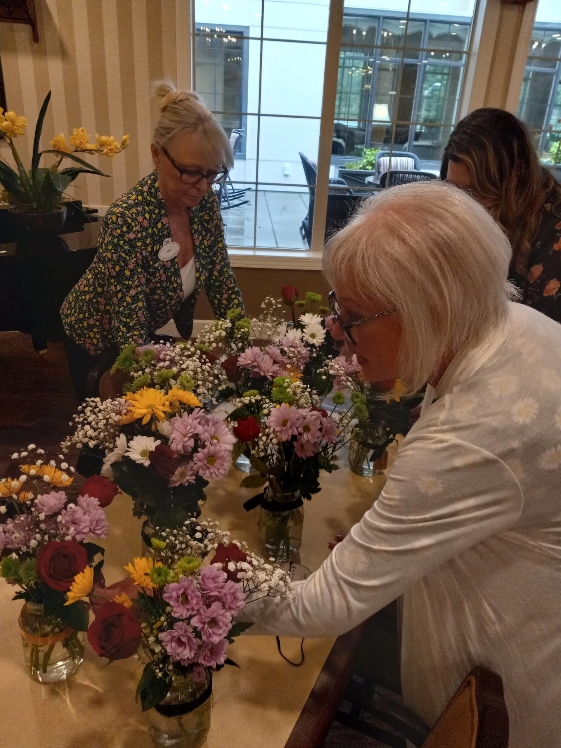 Inspecting hand made flower bouquets. Courtesy of Koelsch Communities.