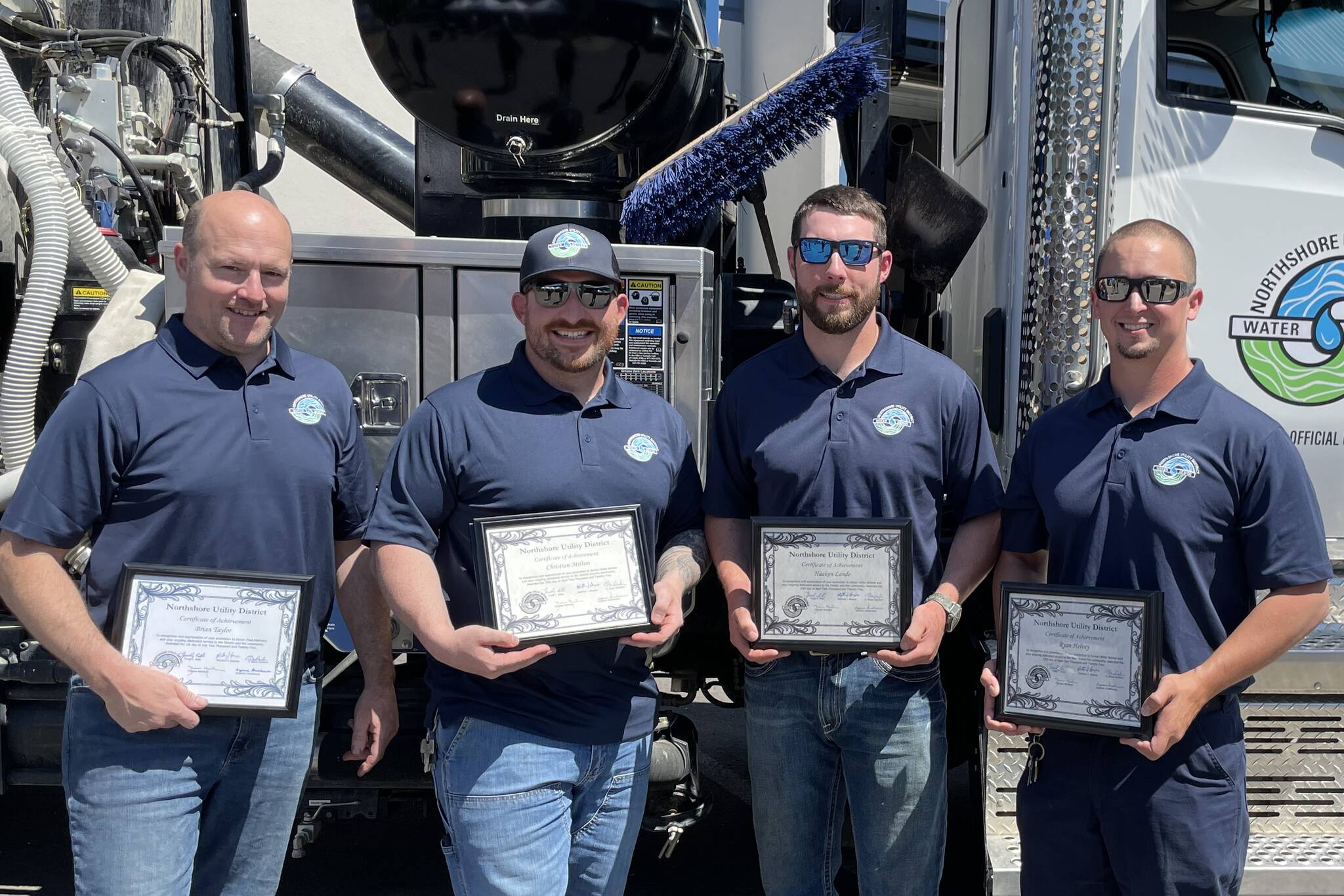 Brian Taylor, Christian Melton, Haakon Lande and Ryan Helvey smile with certificates. Courtesy of NUD.