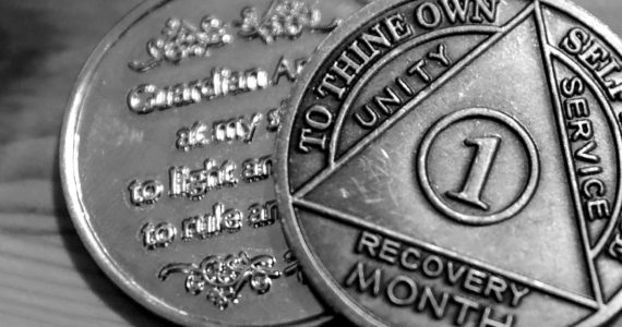 One person’s month recovery coins after battling a fentanyl addiction. (Kevin Clark / The Herald)