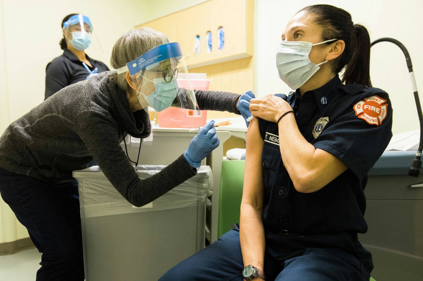 Public Health – Seattle & King County staff administering COVID-19 vaccine to a local emergency responder. COURTESY PHOTO, Public Health-Seattle & King County