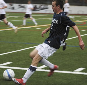 Sophomore Jonathan Ellis heads up field during the Rebels 5-1 loss to Mercer Island in the first round of the KingCo tournament last Monday.