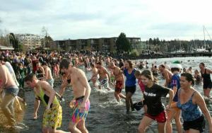 More than 100 shivering swimmers plunged into Lake Washington to ring in the new year during Kirkland's unofficial Polar Bear Plunge event at Marina Park on Sunday afternoon.