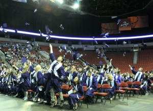 Lake Washington High School seniors throw up their graduation caps during a commencement ceremony on Tuesday at the Key Arena in Seattle.