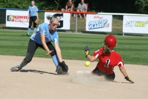 Kirkland's Hannah Walker attempts to tag out Kaitlyn Tucker of the Canadian team during the first day of the Junior Softball World Series at Everest Park Sunday.