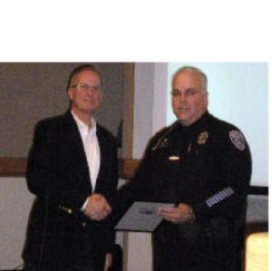 Mayor Jim Lauinger (left) honors Officer Jim Kissinger for 25 years of service.