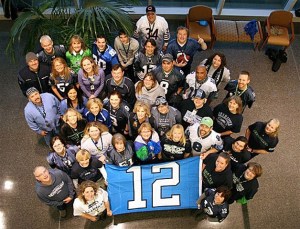 Evergreen Hospital Medical Center employees show off their Seahawks' pride on Friday as the team gets ready for the NFL playoff game against the Chicago Bears on Sunday. One Bears' fan stands in the back.
