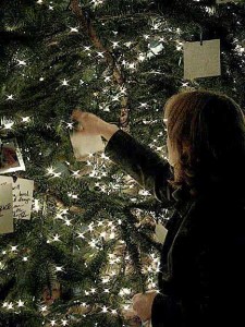 A community member adorns a tree with a special remembrance note during the 'Light Up a Life' ceremony at Evergreen Hospital on Dec. 7.