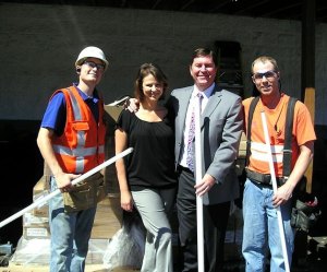 Ford of Kirkland dealer principal Jim Walen (second from right) and CFO Amy Walen (second from left). The business upgraded its lighting system with energy-efficient lighting.