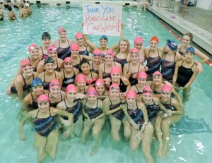 The Juanita High School girls swim and dive team raised money to purchase new swim suits for the 2015 season. The pink caps were for Breast Cancer awareness week.