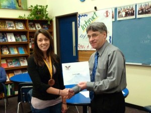 Juanita High School junior Sarah Smith was recently named one of Washington State’s top runners-up in the 2011 Prudential Spirit of Community awards. Sarah was chosen based on her 600-plus hours volunteering at a horse rescue organization in Duvall. Also pictured is principal Gary Moed.