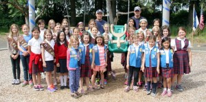 Members of the Holy Family Parish Brownie and Daisy Girl Scout Troops proudly pose with Jim Fitzpatrick and Kyle Johnston