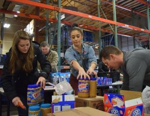 Extreme Consulting Group sorts their team’s Round II donation to Hopelink Can Madness.