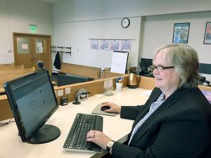 District Court Presiding Judge Donna Tucker demonstrating the online e-mitigation system now available to citizens with traffic tickets.