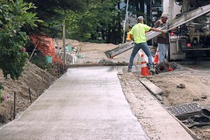 A construction crew pours a second of the Cross Kirkland Corridor.