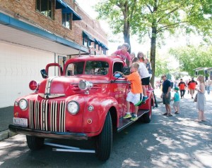 Some kids play on an antique fire truck during the 11th annual Kirkland Classic Car Show in downtown Kirkland on Sunday. The event