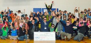 Ford of Kirkland employees and kids form the Kirkland Boys & Girls Club pose for a photo following a large donation by the car dealership.
