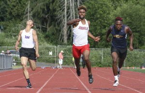 Juanita High junior Salvon Ahmed reaches across the finish line to win the 3A boys’ 100 meters at the KingCo Track and Field championships on Friday