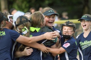 Kirkland softball players celebrate a 1-0 victory over Redmond in the 9/10 District 9 championship game on Monday at Everest Park. JOHN WILLIAM HOWARD/Kirkland Reporter