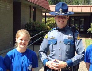 Madison Gray stands with Washington State Trooper Travis Joyce