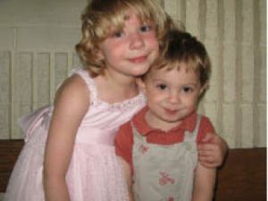 5-year-old Grace Weaver poses with her younger brother. This photo was taken last year