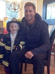 Seattle Seahawks’ place kicker Steven Hauschka visits with Madeline Herman at her Kirkland home on Christmas morning. Hauschka brought the little girl a signed shoe and photograph.