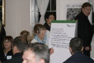 Jessica Pfundt guides her caucus of residents through a series of concerns about the proposed jail. The findings were presented to NEC officials.