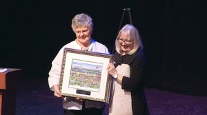 Sue Contreras accepts the CACHET Award from Major Joan McBride for her efforts in fundraising for the restoration of the Capt. Anderson Ferry Clock and for her volunteer support of Summerfest.