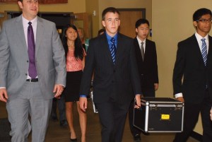 International Community School principal Matthew Livingston escorts students Dorothy Jiang