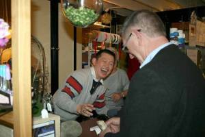 Simplicity Decor owner A. Suraphong shares a laugh with a customer on Wednesday afternoon