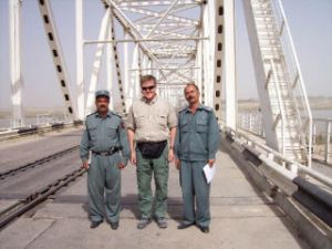 Juha Salin stands with border police chiefs at the “Peace Bridge” from Afghanistan to Uzbekistan. It is the same bridge used by the Soviet Union to invade Afghanistan in 1979 and exit in 1989.