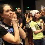 A woman appears worried as the national election results come in (Allison DeAngelis/staff photo).