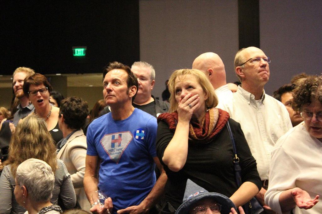 People anxiously watch the national election results come in at the Washington State Democrats election night party on Nov. 8, 2016 (Allison DeAngelis/staff photo).