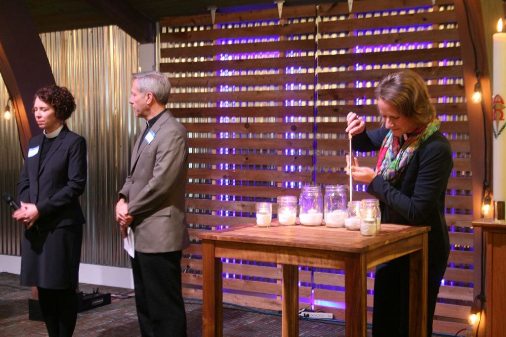 Salt House Pastor Sara Wolbrecht (right) lights candles as other faith leaders read prayers to bless the New Bethlehem Day Center. CATHERINE KRUMMEY/Kirkland Reporter