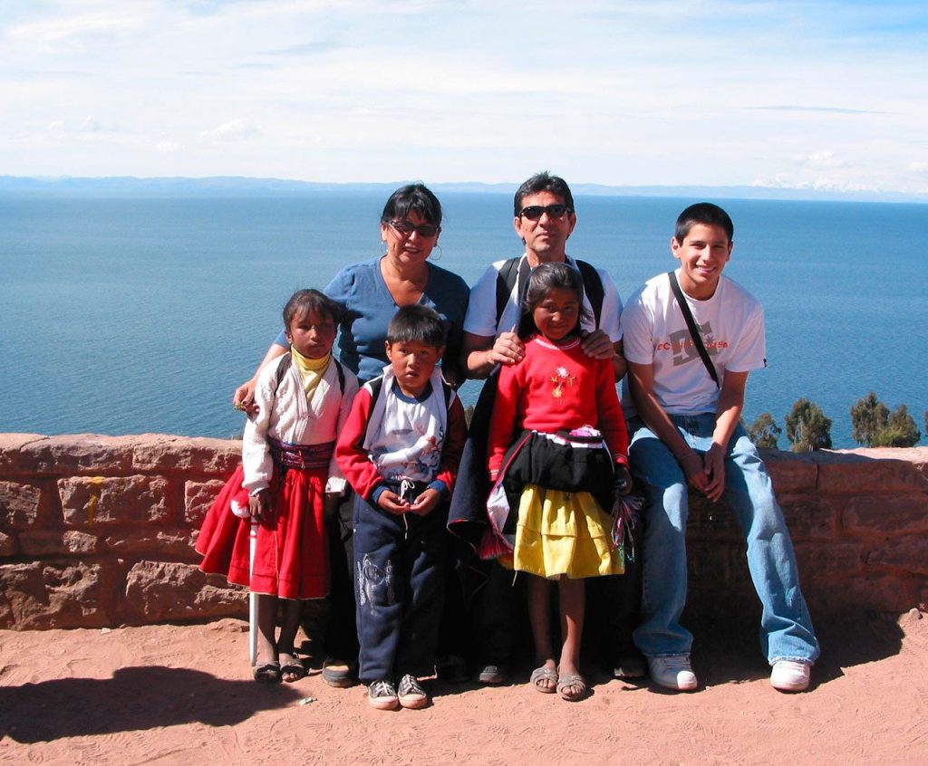 Kirkland resident Matilde Melendez (back row, left) poses for a photo with her husband, Armando Melendez; her son, Armando Melendez; and some local children. near Lake Titicaca in Peru. She has started her own business, Conquer Peru, in which she coordinates travel plans to the country for customers. Submitted photo