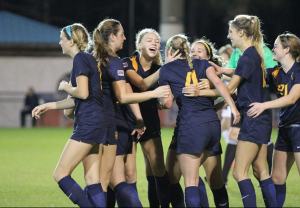 The Northwest University women&rsquo;s soccer team celebrates during an NAIA tournament match in November. The Eagles made NAIA history as the first unseeded team to ever make the national semifinals. Courtesy photo