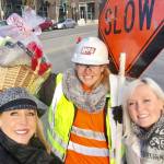 Barbie Collins Young (left) and Jody Anderson (right) present Felicia Porter with a holiday gift basket outside of the Kirkland Urban construction site, where Porter works as a flagger. The gift basket is filled with items from appreciative Kirkland residents. Contributed photo