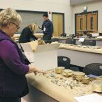 Gail Genereau of Lake Forest Park scours the items recovered from the &ldquo;Movie Bandits&rdquo; burglaries in 2012 at the Redmond Police Department as the result of a Pro-Act investigation. She found some of her stolen jewelry. File Photo