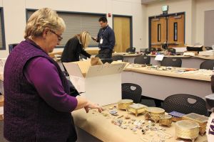 Gail Genereau of Lake Forest Park scours the items recovered from the &ldquo;Movie Bandits&rdquo; burglaries in 2012 at the Redmond Police Department as the result of a Pro-Act investigation. She found some of her stolen jewelry. File Photo