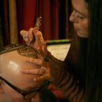 Kirkland artist Sarah Walters creates a henna crown for Mary Glasco at Sankara Imports in Bothell. CATHERINE KRUMMEY/Kirkland Reporter