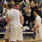 Lake Washington&rsquo;s Philip Roe hugs teammate Griffin Barker (11) after the Kangs defeated the Islanders 61-60 Friday at Lake Washington High School. Joe Livarchik/Mercer Island Reporter