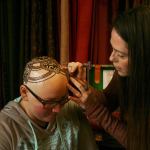 Kirkland artist Sarah Walters creates a henna crown for Mary Glasco at Sankara Imports in Bothell. CATHERINE KRUMMEY/Kirkland Reporter