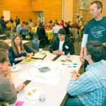 Peter Kageyama (standing at right) discusses a T-shirt design with Kenmore residents at a &ldquo;For the Love of Kenmore&rdquo; event in 2015. Kageyama will host a workshop at &ldquo;For the Love of Kirkland&rdquo; on Jan. 23. Reporter file photo