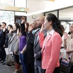 Local immigrants take the Oath of Allegiance to become U.S. citizens during a naturalization ceremony at the Kingsgate Library. KATHY CUMMINGS/Contributed photo