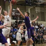 Mercer Island senior Jacob Evans (44) blocks a shot attempt by Lake Washington&rsquo;s Beau Heimdahl in the second half of Saturday&rsquo;s conference semifinal at Mercer Island High School. JOHN WILLIAM HOWARD/Kirkland Reporter