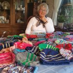 Molly Michener takes a photo with some of the hats she knitted for Syrian refugees. SUSAN FITZGERALD / Contributed photo