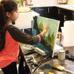 Ira Ganjikunta, 6, works on a painting at her Redmond home. CATHERINE KRUMMEY/Kirkland Reporter